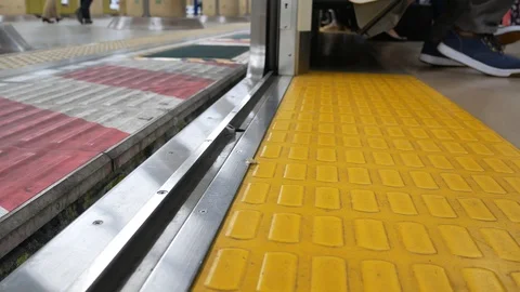 Lower on the floor of the train's door while the door is closing . Japan Stock Footage 119266180