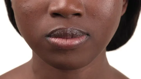 Lower half face view of a black woman eating a French fry then smiles. Isolated Stock Footage 209322099