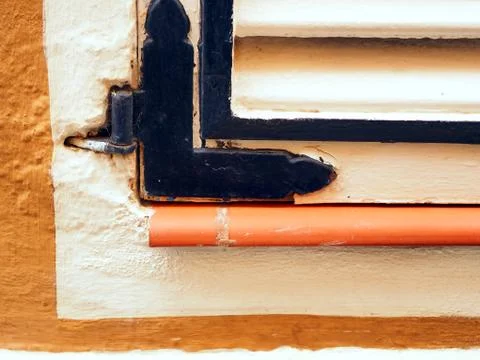 Lower left section of a shutter on a house wal Stock Photos
