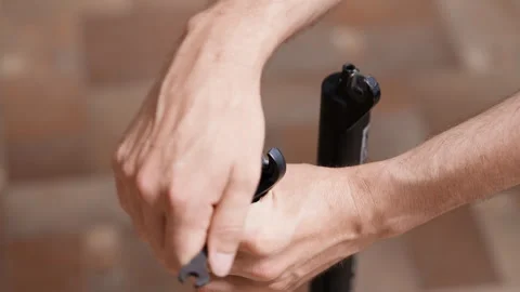 Lower leg fork service, unscrewing the bolts, bicycle suspension fork Stock Footage 280490337