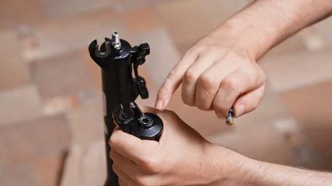 Lower leg fork service, unscrewing the bolts, bicycle suspension fork Stock Footage 280491320