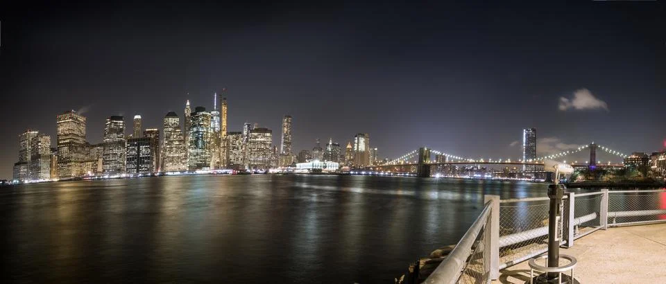 Lower Manhattan, its skyline and the Brooklyn Bridge at night, seen from Br.. Stock Photos