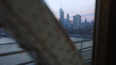 Lower Manhattan skyline from subway train window at dusk New York City New York. Video stock 346985408