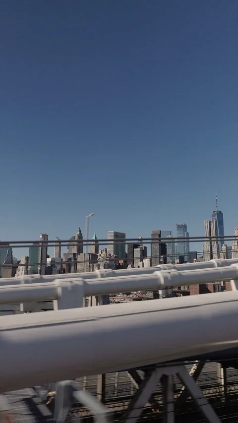 Lower Manhattan skyline view through bridge structure in New York City Stock Footage 333297047