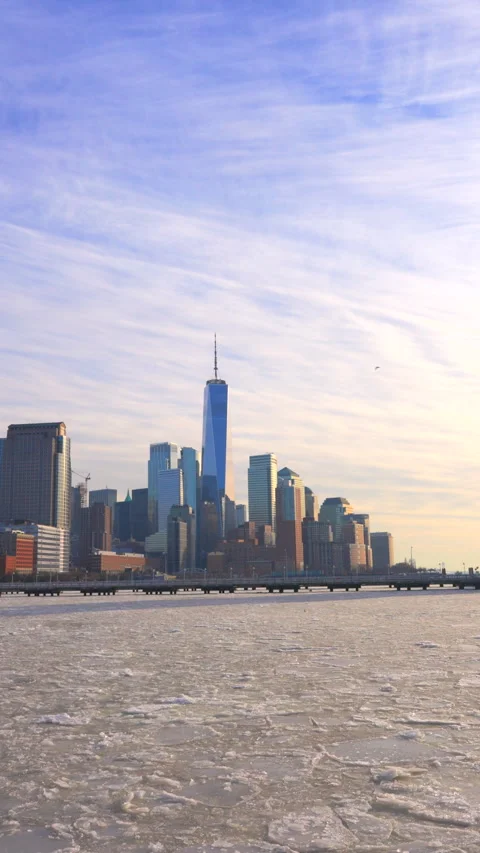 Lower Manhattan skyscraper stands behind frozen Hudson River in New York City. Stock Footage 300741842