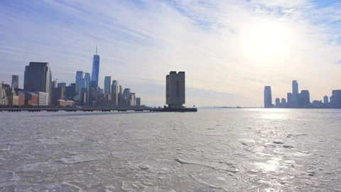 Lower Manhattan skyscraper stands behind frozen Hudson River in New York City. Stock Footage 300803565