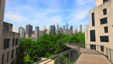 Lower Manhattan skyscraper stands beyond the Squibb Park Bridge in New York City Stock Footage 242133601