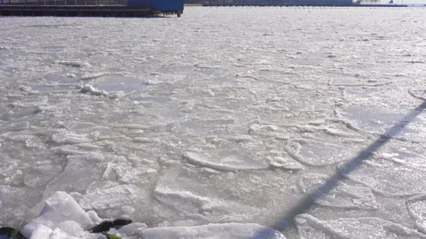 Lower Manhattan skyscraper stands beyond frozen Hudson River in New York City. Stock Footage 300516588