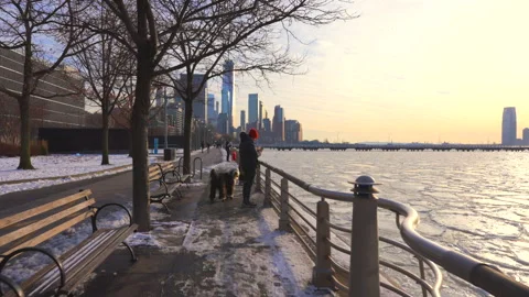 Lower Manhattan skyscraper stands beyond frozen Hudson River in New York City. Stock Footage 300901739