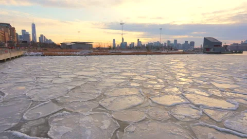 Lower Manhattan skyscraper stands beyond frozen Hudson River in New York City. Stock Footage 301231680