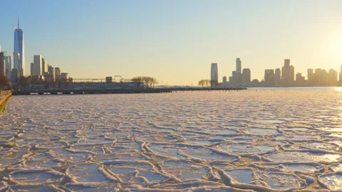 Lower Manhattan skyscraper stands beyond frozen Hudson River in New York City. Video stock 301304182