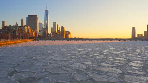 Lower Manhattan skyscraper stands beyond frozen Hudson River in New York City. Stock Footage 301329658