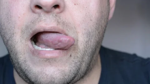 Lower part of the face of a middle-aged man. eats and licks his lips. close up s Stock-Footage 256321877