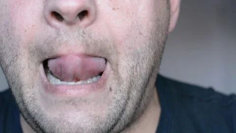 Lower part of the face of a middle-aged man. eats and licks his lips. close up s Stock-Footage 256321895