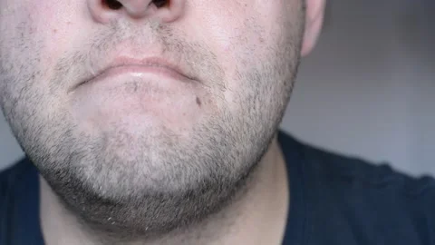 Lower part of the face of a middle-aged man. eats and licks his lips. close up s Stock-Footage 256321988