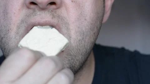Lower part of the face of a middle-aged man. eats and licks his lips. close up s Stock-Footage 256322084