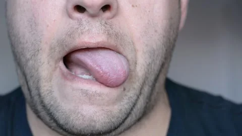 Lower part of the face of a middle-aged man. eats and licks his lips. close up s Stock-Footage 256322214