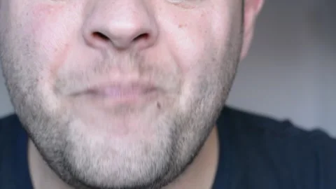 Lower part of the face of a middle-aged man. eats and licks his lips. close up s Stock-Footage 256322262