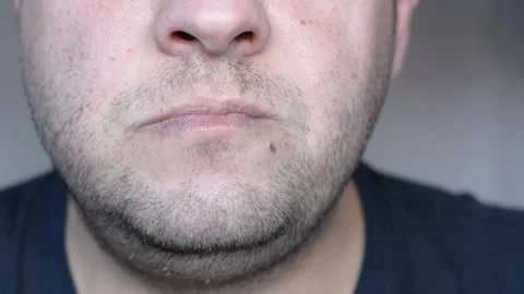 Lower part of the face of a middle-aged man. eats and licks his lips. close up s Stock-Footage 256322427