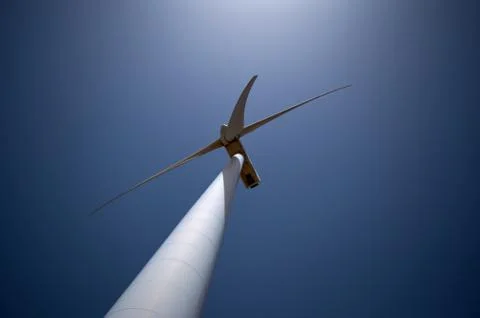 Lower plane of the tower of a windmill with its blades Stock Photos
