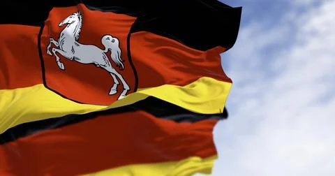Lower Saxony state flag waving with German flag on a clear day Stock Illustration