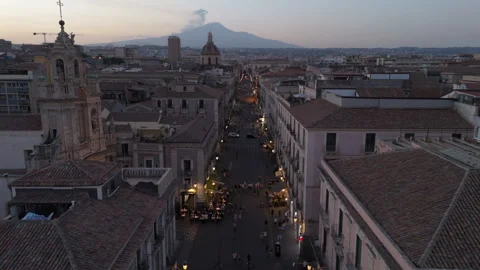 Lower sunset flying over street towards Mt. Etna in Catania Sicily Stock Footage 280179425