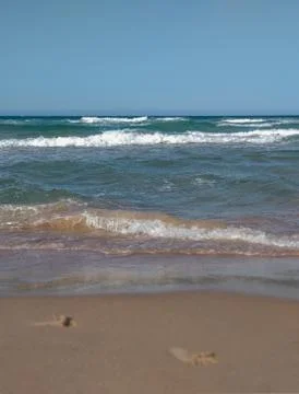 Lower view of the beach shore with some waves Stock Photos