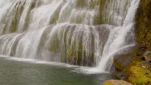 Lower view of the waterfall flowing into the river Stock Footage 249208405