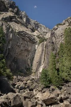 Lower Yosemite Fall thin water stream trickle flowing over dry granite rock.. Stock Photos