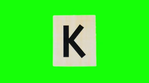 Lowercase letter k on ripped sheet of paper filmed in stop motion against alpha Stock Footage 251832267