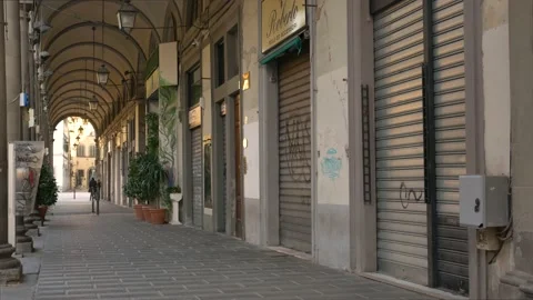 Lowered shutters, empty streets during Covid-19 pandemic lockdown. Ghost town. 库存影片 144437117