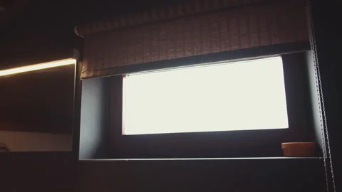 Lowering the blinds covering the rectangular window Stock Footage 156300623