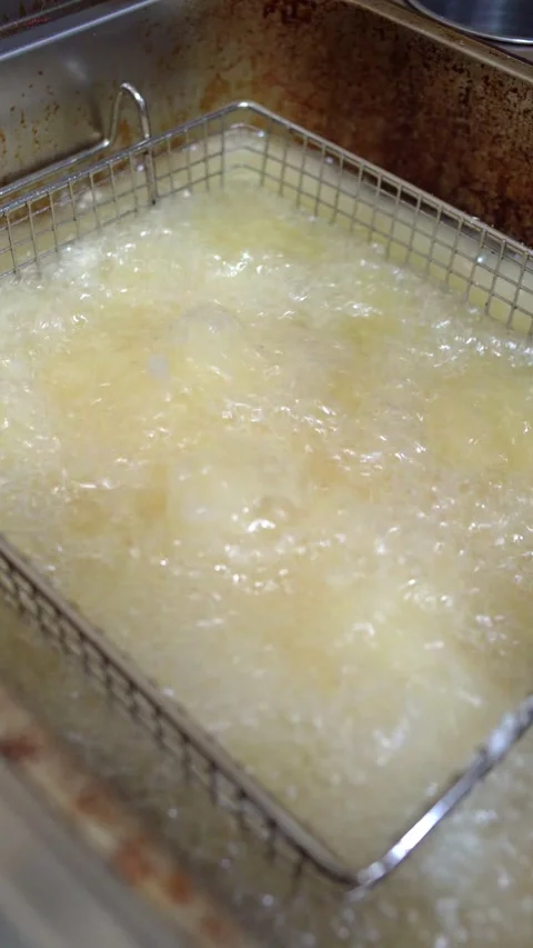 Lowering Chicken Into Boiling Hot Oil Stock Footage 343201408