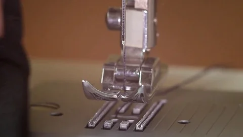 Lowering the sewing machine foot and beginning the stitching Stock Footage 82354755
