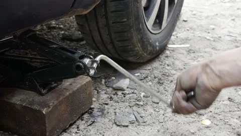 Lowering the vehicle with a jack Stock Footage 156540902