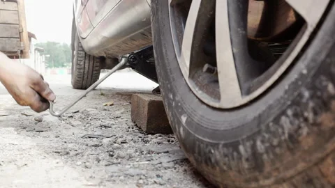 Lowering the vehicle with a jack Stock Footage 156541184