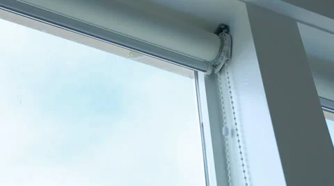Lowering a window shade in a house Stock Footage 32905977