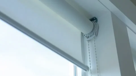 Lowering the window shade in a house Stock Footage 32908103