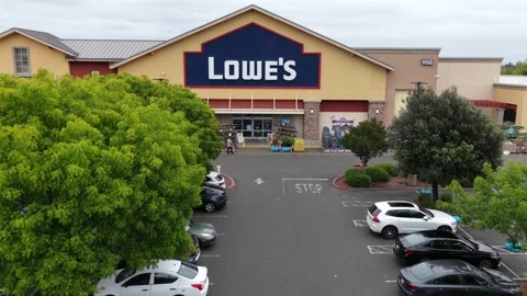 Lowe’s home improvement store with large blue signage, parking lot with Stock-Footage 336686881