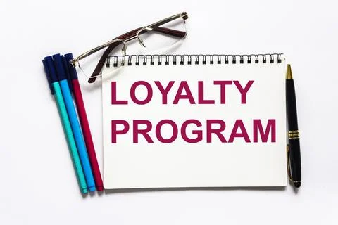 Loyalty program card with white background and a pen, glasses and markers nea Stock Photos