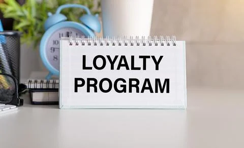 Loyalty Program text on a notepad on chart with keyboard and calculator Stock Photos
