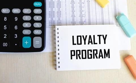 Loyalty Program text on a notepad on chart with keyboard and calculator. Stock Photos