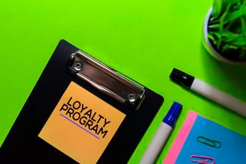 Loyalty Program write on sticky notes. Isolated on green table background Stock Photos