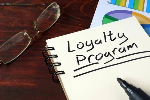 Loyalty Program written on note with charts. Stock Photos