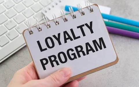 A Loyalty Program is written on a piece of paper, Building customer loyalty.. Fotos de archivo