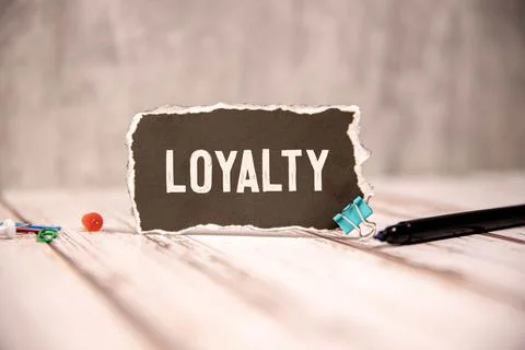 Loyalty text on a notepad on chart with keyboard and calculator. Stock Photos