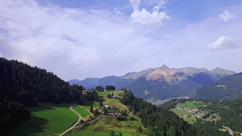 Lpine mountains in summer with chalets on slope and city of Morzine in the Stock Footage 317816472