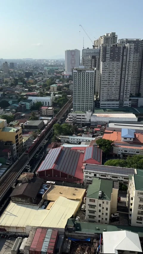 LRT 1 Train Passing Pasay City Skyline High Angle Urban Traffic Manila 4K 60fps Stock Footage 338185608
