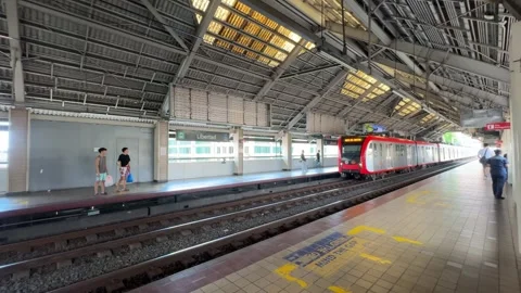 LRT 1 train stopped at commuter station platform in Manila 4K Stock Footage 337451064