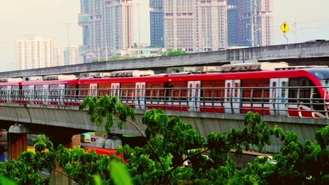 LRT Jabodebek passes through the track Stock Footage 330566726